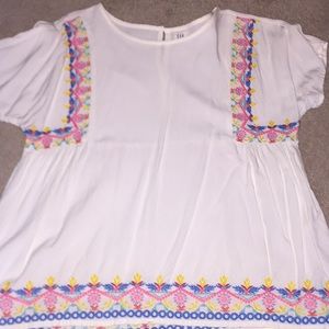 A white flowered detailed blouse for girls